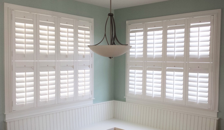 Soft green wall in Destin kitchen with shutters.